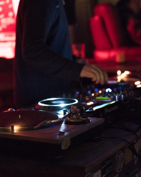 person using DJ controller while standing
