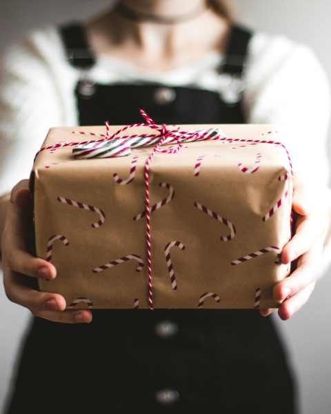 person showing brown gift box