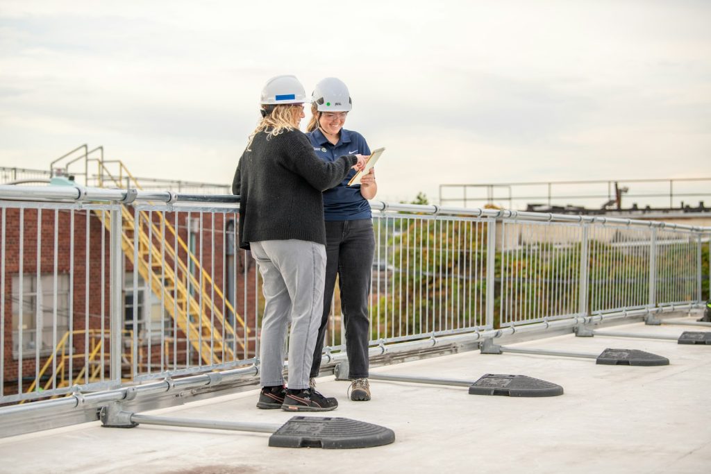 a couple of people standing on top of a roof