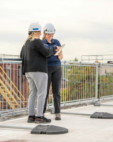 a couple of people standing on top of a roof