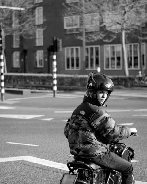 grayscale photo of man riding motorcycle