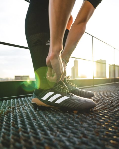 man holding shoelaces