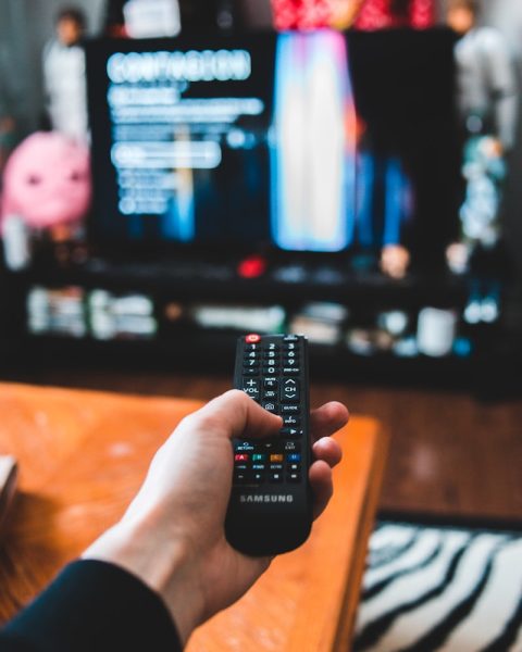 person holding black remote control