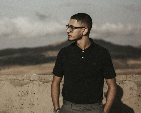 a man standing in front of a concrete wall