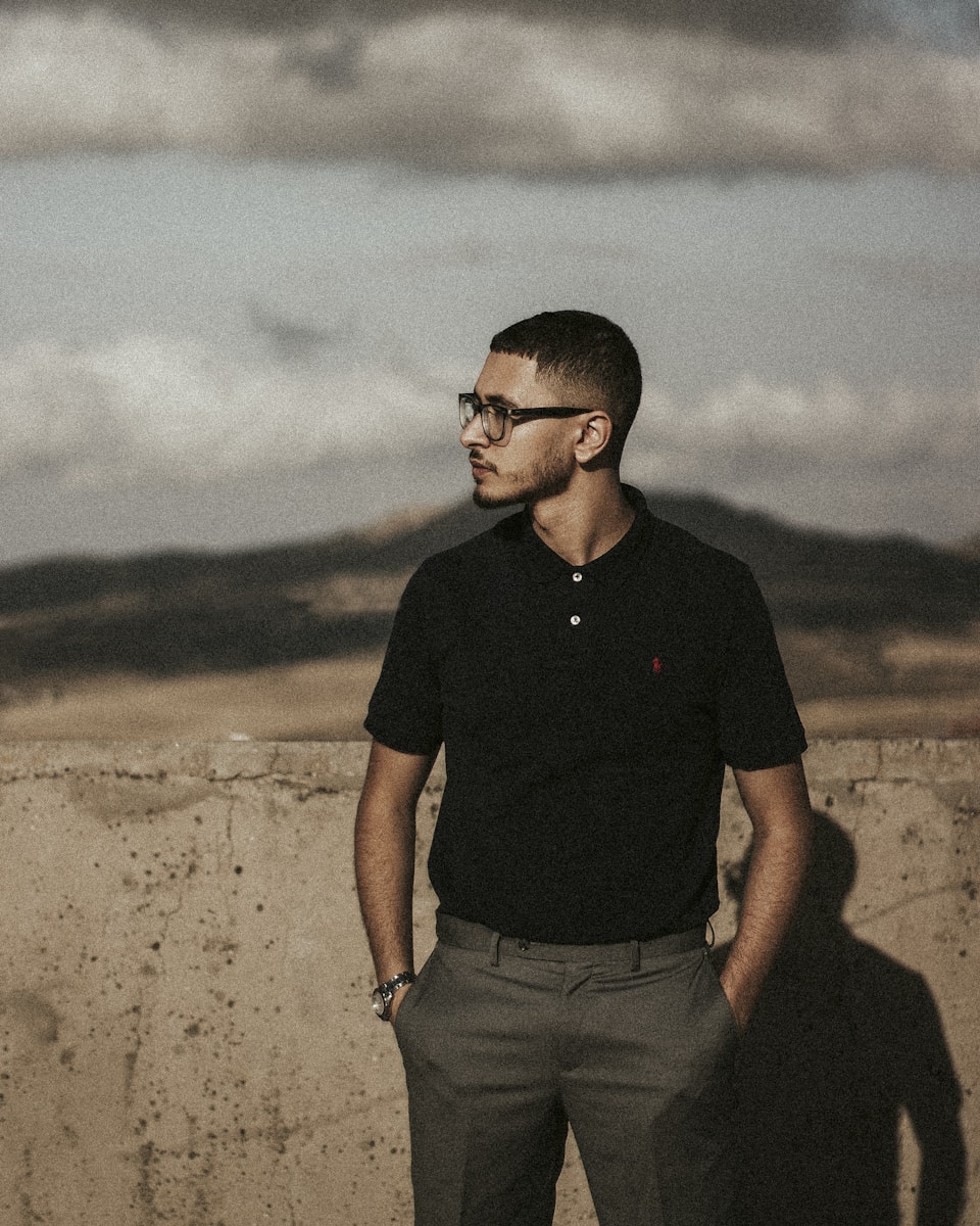 a man standing in front of a concrete wall