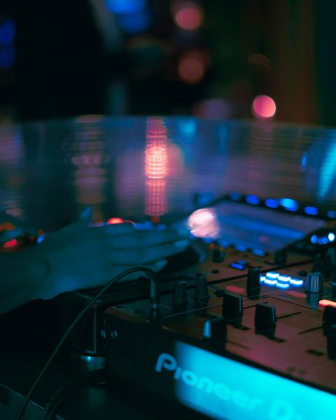 a dj mixing a track in a dark room