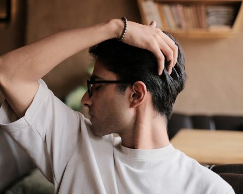 a man in a white shirt and black glasses