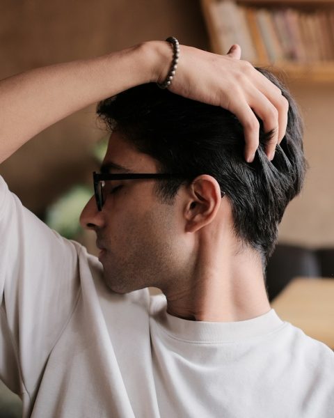 a man in a white shirt and black glasses