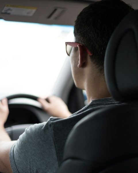 man driving car during daytime