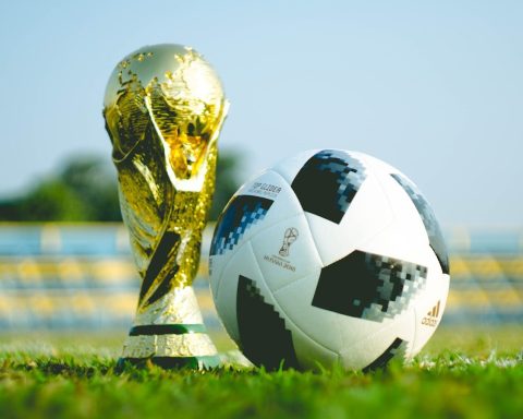 gold-colored trophy and soccerball