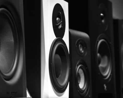 black and gray speakers on brown wooden table
