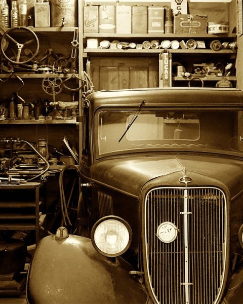 Monteur inspecteert een klassieke auto in een garage
