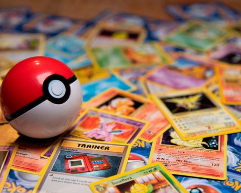 A red and white plastic ball resting on a pile of trading cards