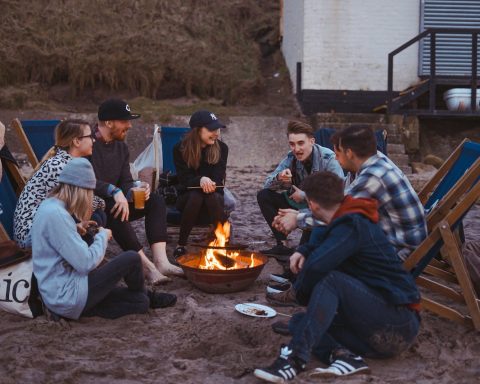 group of people sitting on front firepit
