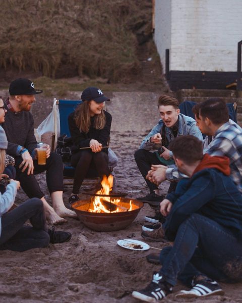 group of people sitting on front firepit