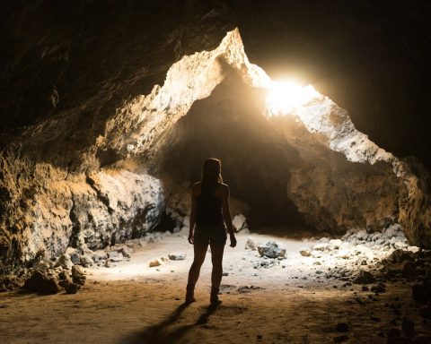 woman standing inside cave