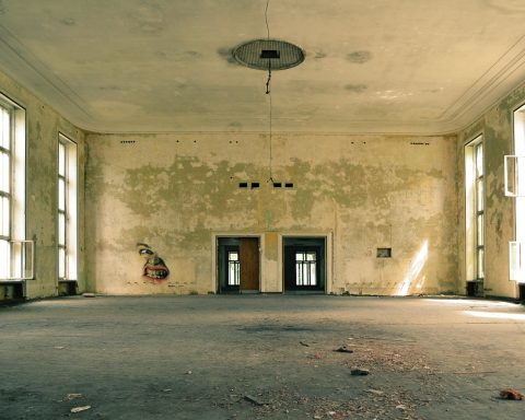 Een betonnen vloer in een lege kamer die wordt geëgaliseerd voor het leggen van laminaat of tegels